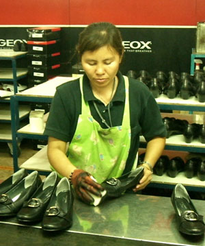 A worker at the AA Footwear Factory in Bangkok inspects and polishes a Cartier-brand shoe made for the Thai domestic market, 2007. Photo Credit: Center for Southeast Asian Studies, University of Michigan, reproduced with permission
